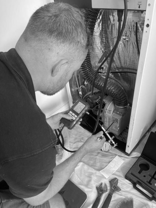 Champion Plumbing engineer servicing a boiler near Ely, Cambridge.